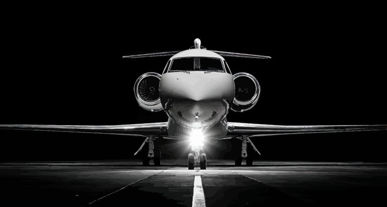 Private jet on runway, showcasing sleek design and lighting, symbolizing luxury travel for SEO-focused private jet charter services.